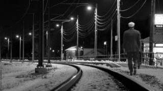 man walking railway track