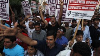Immigrants shout slogans during an anti-racism rally in Nikaia